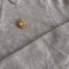Pin Christian Dior – złota rozetka z kryształem