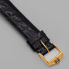 Zegarek Gucci 3000 Series - elegancka złota koperta z czarną tarczą na skórzanym pasku, lata 80./90.